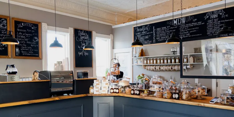 Woman behind counter of a pastry cafe