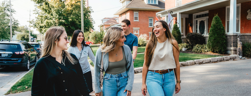 group of young people walking in a vibrant downtown area