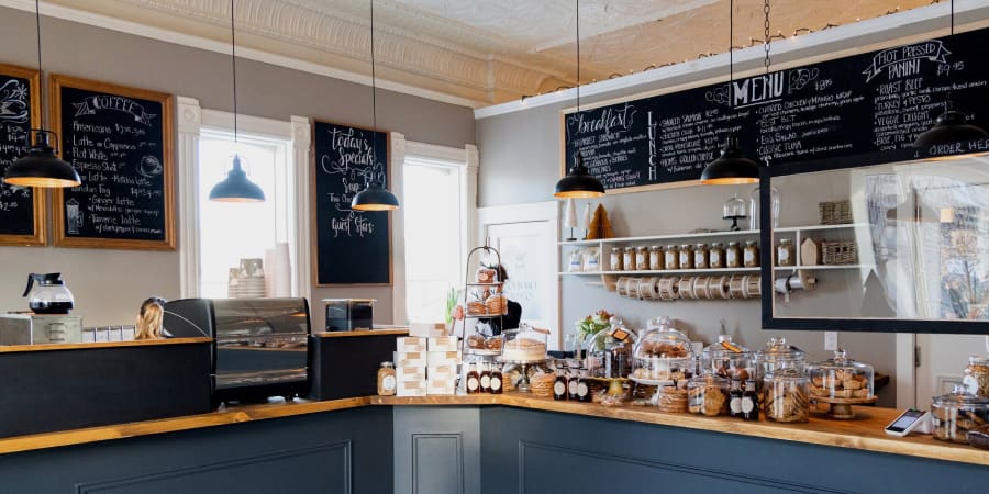Woman behind counter of a pastry cafe