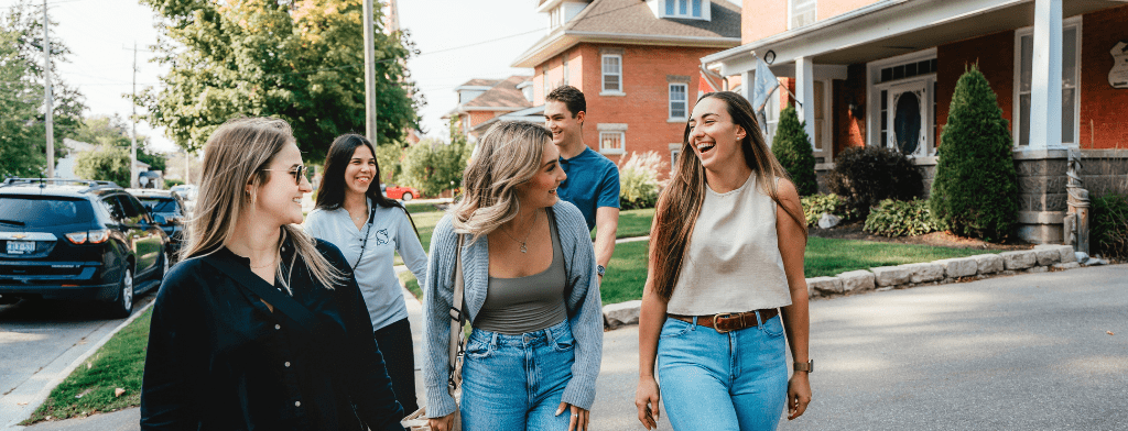 group of young people walking in a vibrant downtown area